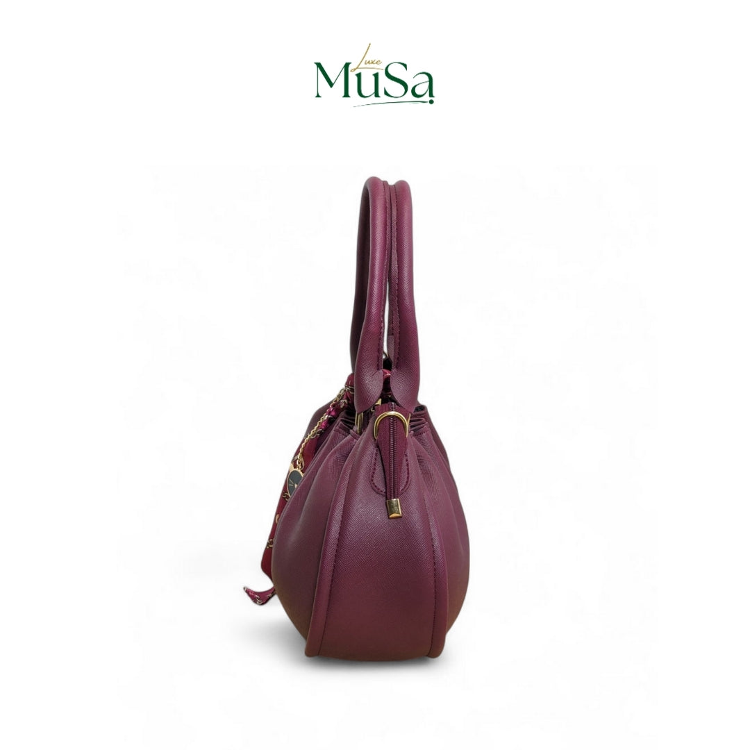 Purple handbag with a visible brand logo on a white background
