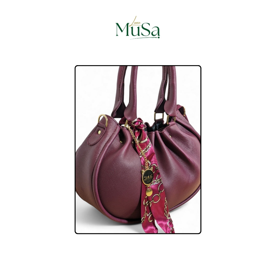 Purple handbag with a colorful strap on a white background, featuring the brand 'Luxe MuSa'.